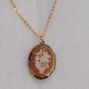 Cameo locket on a gold tone chain
